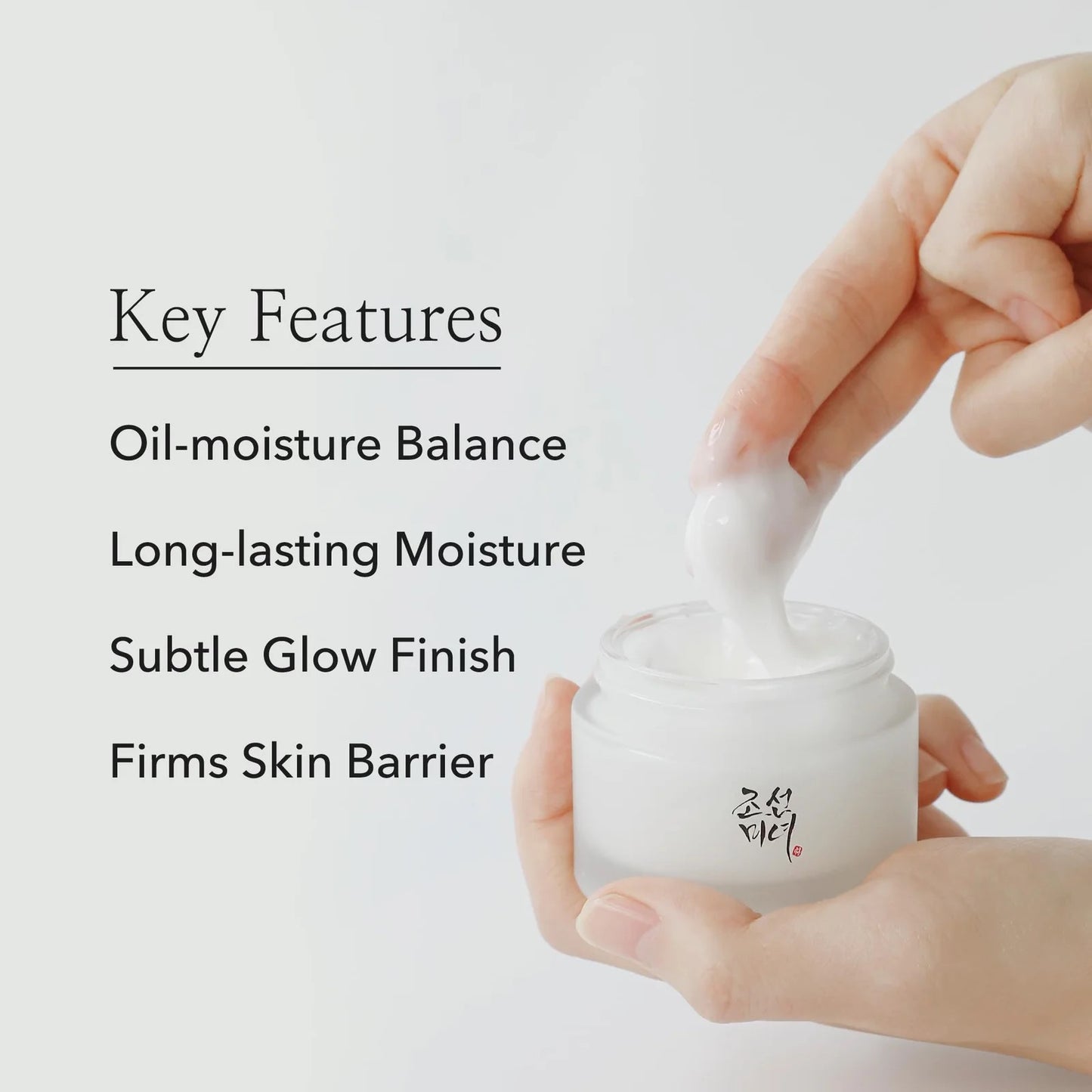 Hand holding a jar of cream with text highlighting key features on a light background