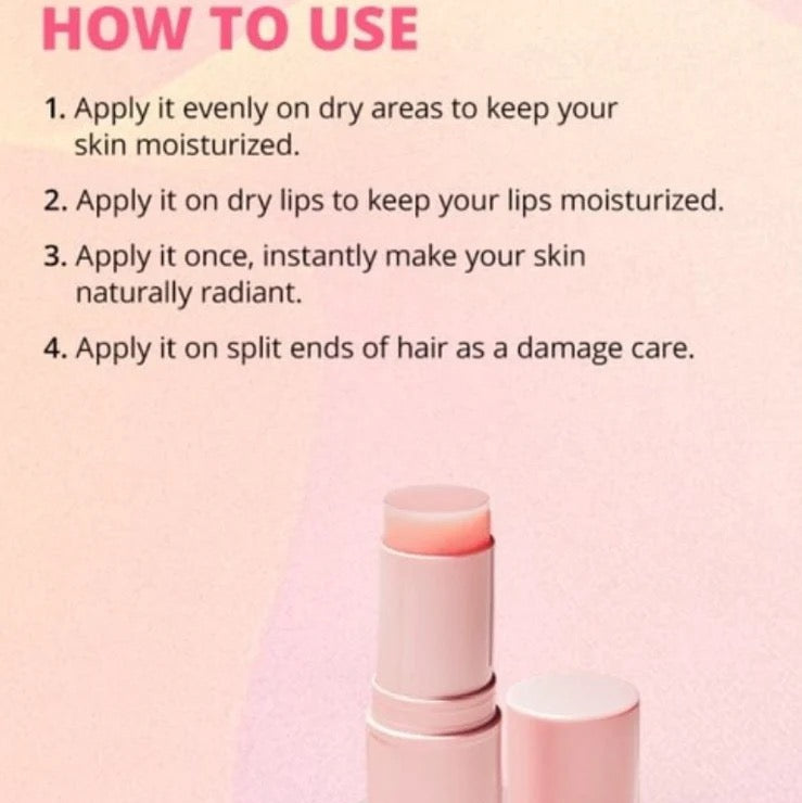 Pink lip balm with usage instructions on a pink background