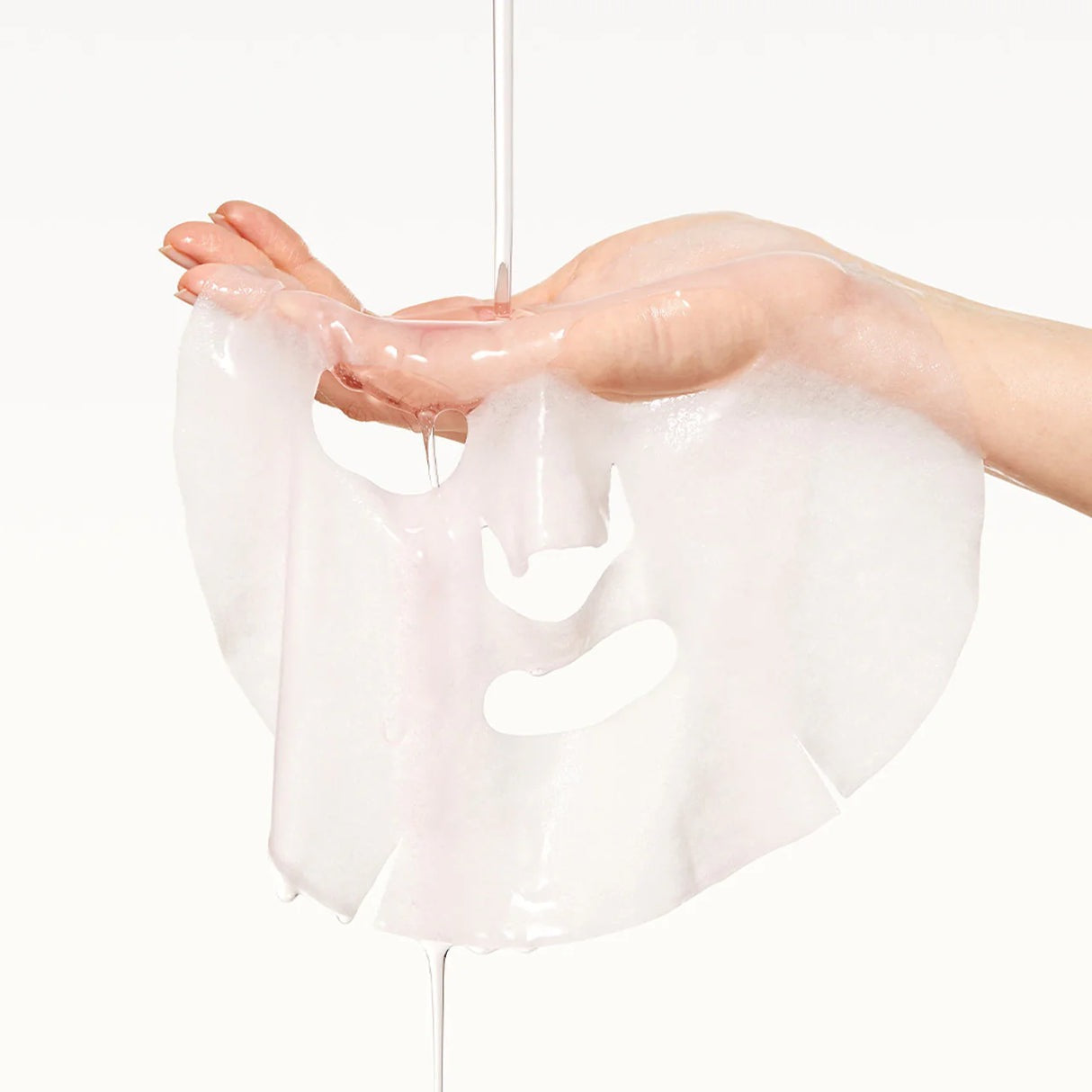Clear plastic wrap held by a hand on a white background
