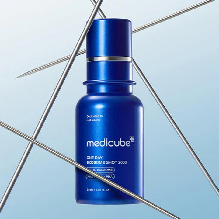 Blue Medicube skincare serum bottle on a light blue background with geometric shapes.