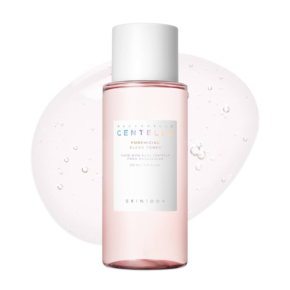 Skincare bottle with pink liquid and white cap on a white background