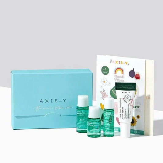 Axis-Y skincare product set with bottles and a box on a light gray background