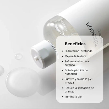 Skincare bottle with benefits listed on a gray background