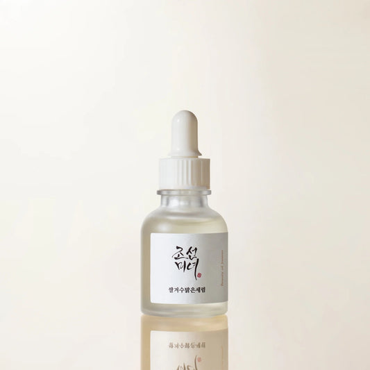 Skincare dropper bottle with a label on a light beige background