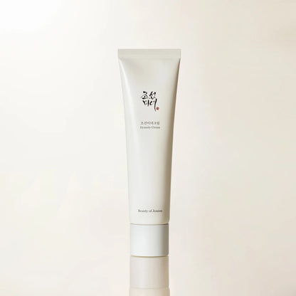 Skincare cream tube with brand logo on a light beige background