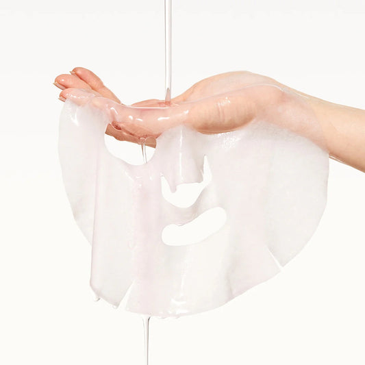 Clear plastic wrap held by a hand on a white background