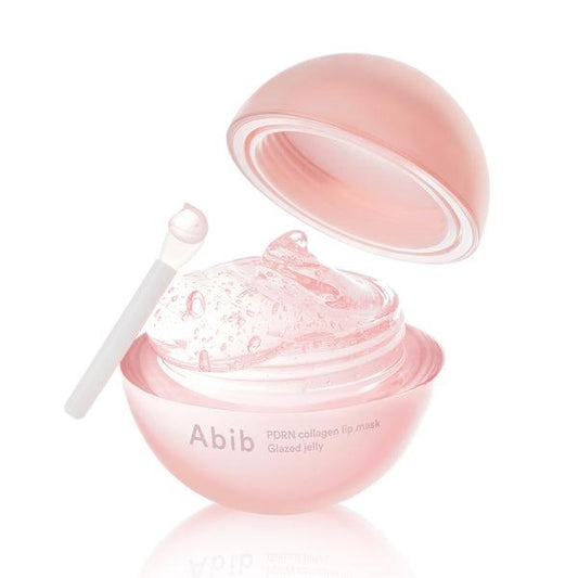 Pink skincare product with a spoon on a white background