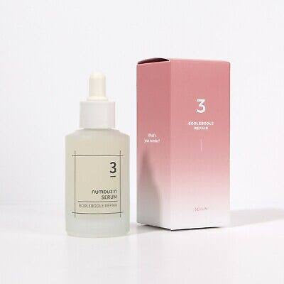 Skincare serum bottle with dropper and pink packaging on a white background