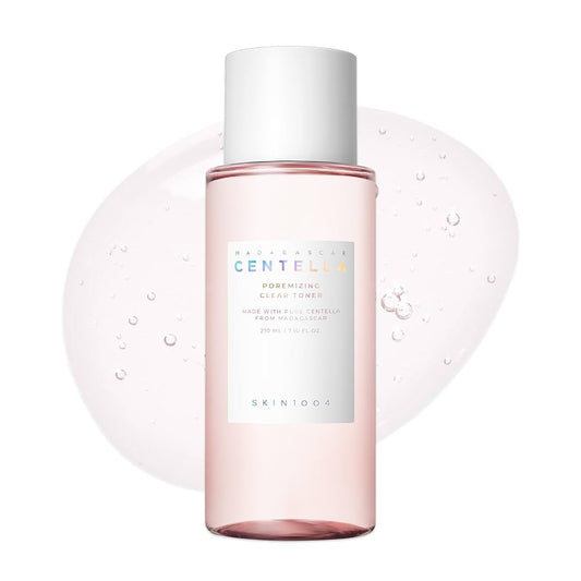 Skincare bottle with pink liquid and white cap on a white background